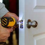 Carpenter Install Door Lock Using Screwdriver At Home